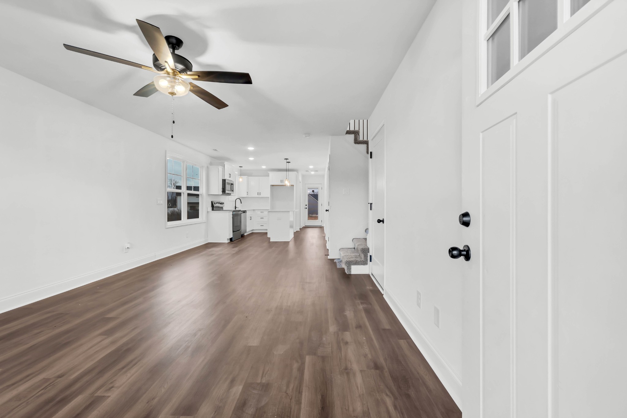 187 Quarry View Clarksville, TN 37043 - Photo 3 of 36 a view of a hallway with wooden floor and a ceiling fan
