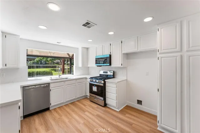 a kitchen with granite countertop a stove and a sink