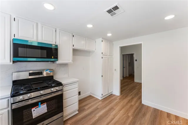 a kitchen with a stove and a microwave