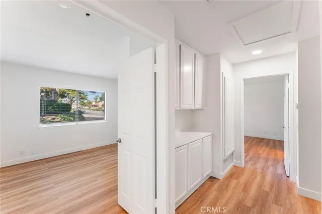 a view of hallway with wooden floor