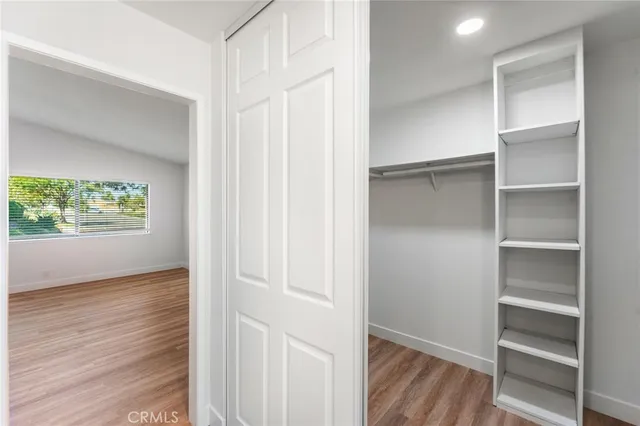 a view of walk in closet with empty racks