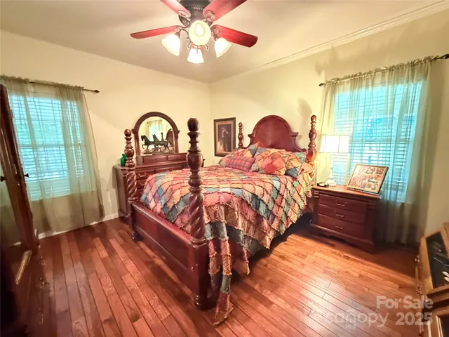 a bedroom with two beds and a large window