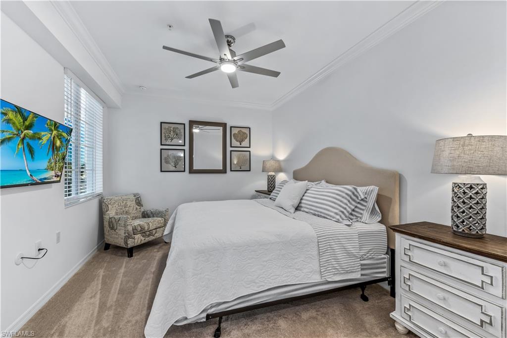 43030 Greenway Boulevard, Unit 423 Babcock Ranch, FL 33982 - Photo 7 of 11 a bedroom with a bed and a chandelier