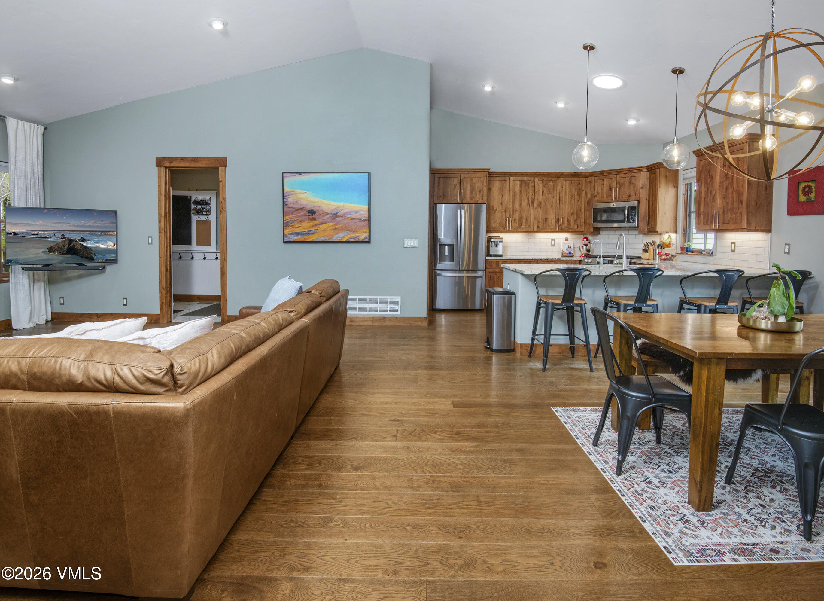 135 Palmer Loop Eagle, CO 81631 - Photo 12 of 54 a living room with dining room and wooden floor