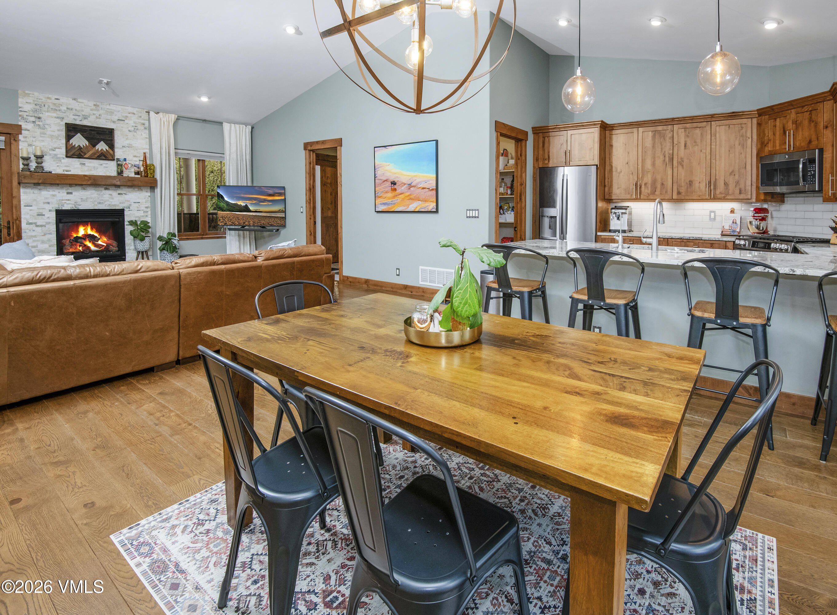 135 Palmer Loop Eagle, CO 81631 - Photo 18 of 54 a kitchen with stainless steel appliances granite countertop a table chairs sink and cabinets