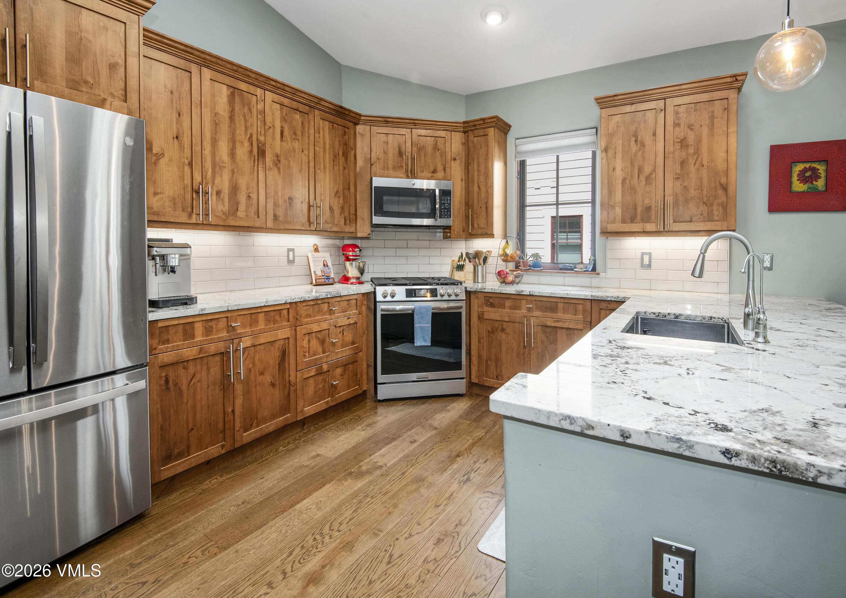 135 Palmer Loop Eagle, CO 81631 - Photo 21 of 54 a kitchen with stainless steel appliances granite countertop a sink stove refrigerator and wooden cabinets