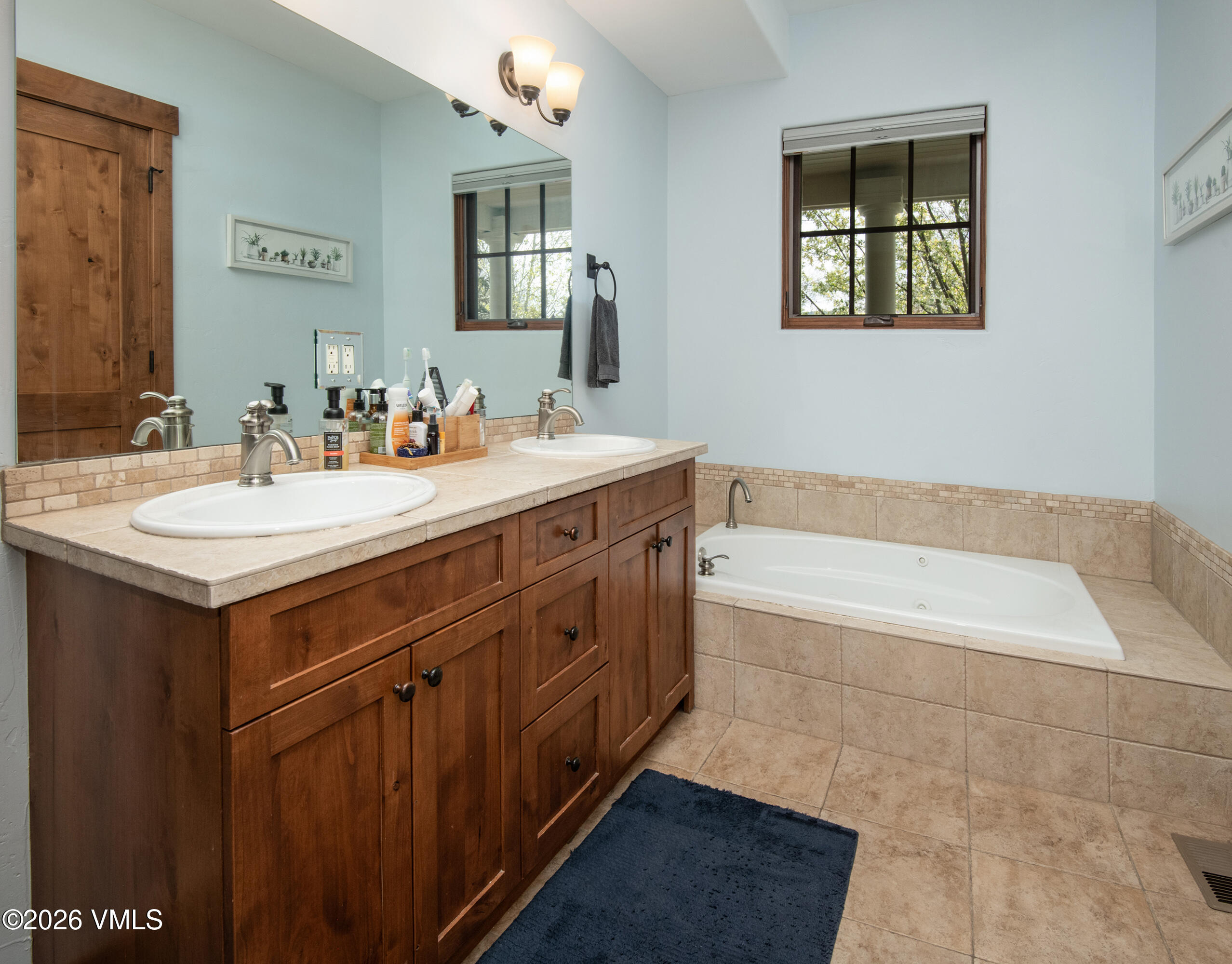 135 Palmer Loop Eagle, CO 81631 - Photo 26 of 54 a spacious bathroom with a tub sink and mirror