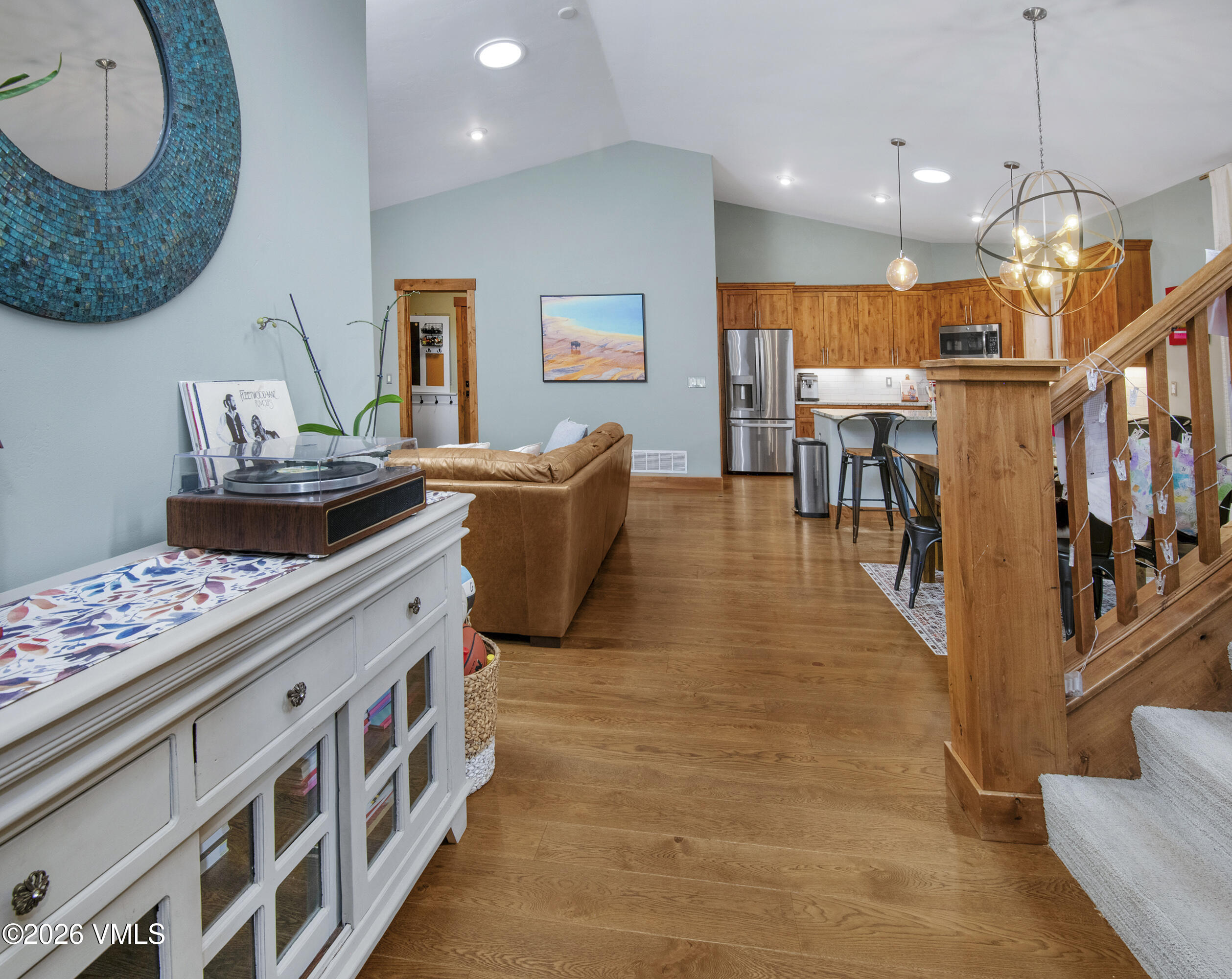 135 Palmer Loop Eagle, CO 81631 - Photo 6 of 54 a kitchen with stainless steel appliances granite countertop a stove a sink a dining table and chairs with wooden floor
