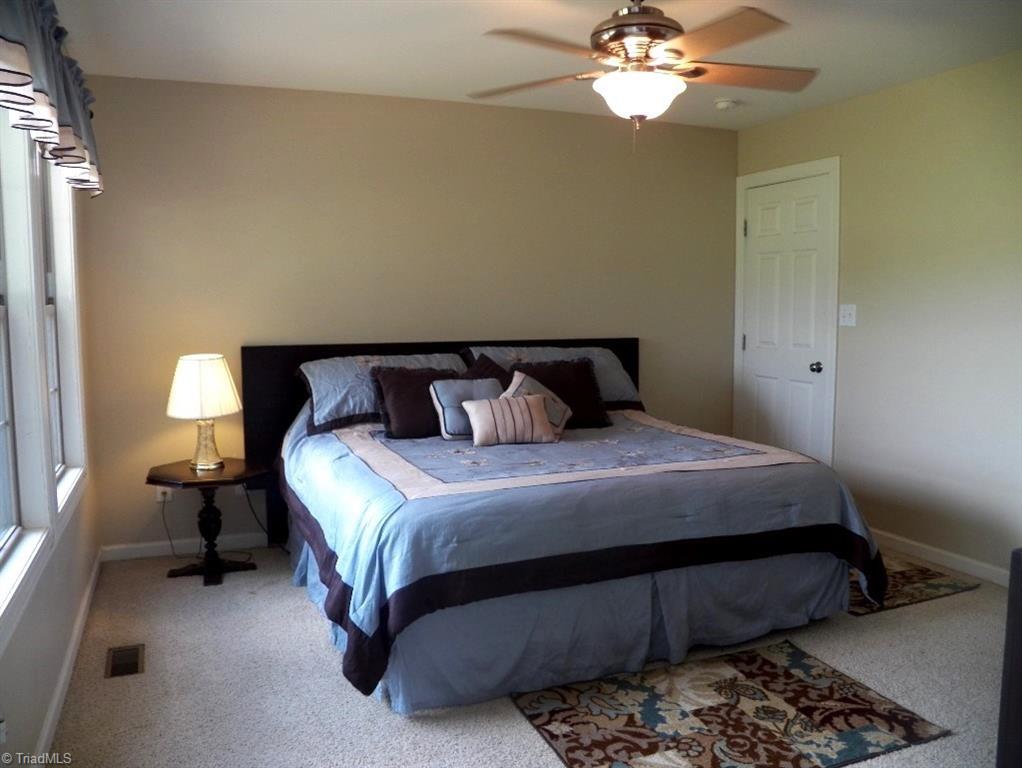 859 Riverview Rd Extension Lexington, NC 27292 - Photo 15 of 26 Master Bedrooms with double windows and sliding door to back deck. Plenty of space for this king size bed and extra bedroom furniture. Walk-in closet - no shown.