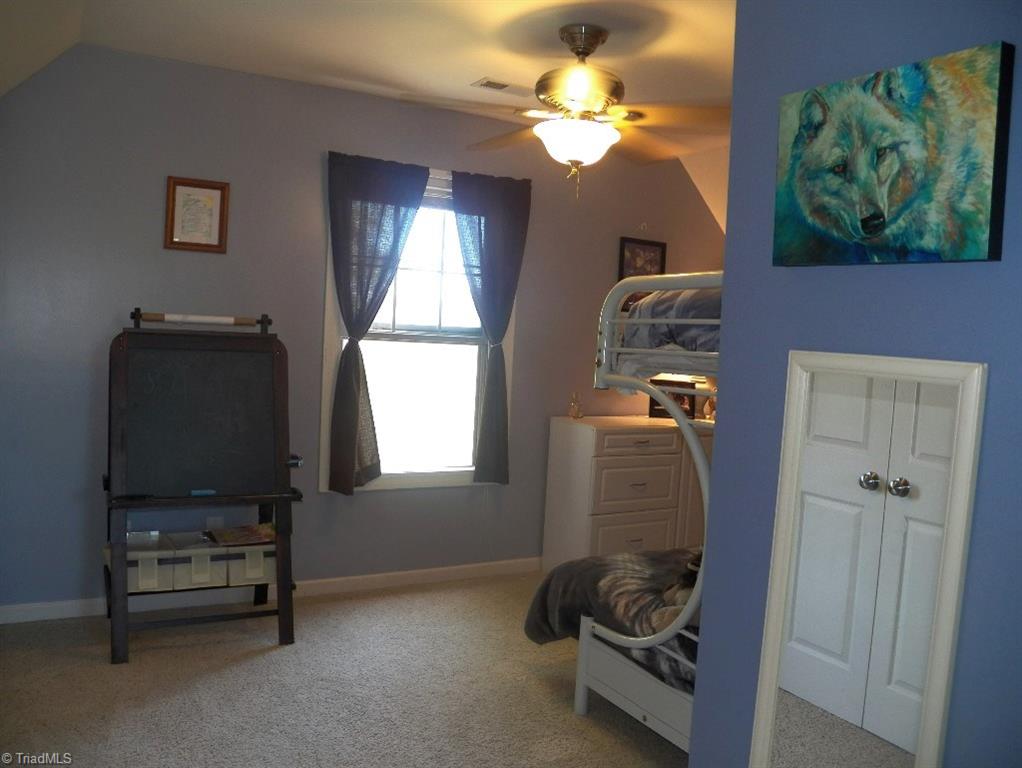 859 Riverview Rd Extension Lexington, NC 27292 - Photo 21 of 26 Another view of the upstairs bedroom. Wall of closet doors on left - shown in mirror on right. Bathroom for this bedroom is on the right -not shown - give bedroom and bath privacy from the loft area.