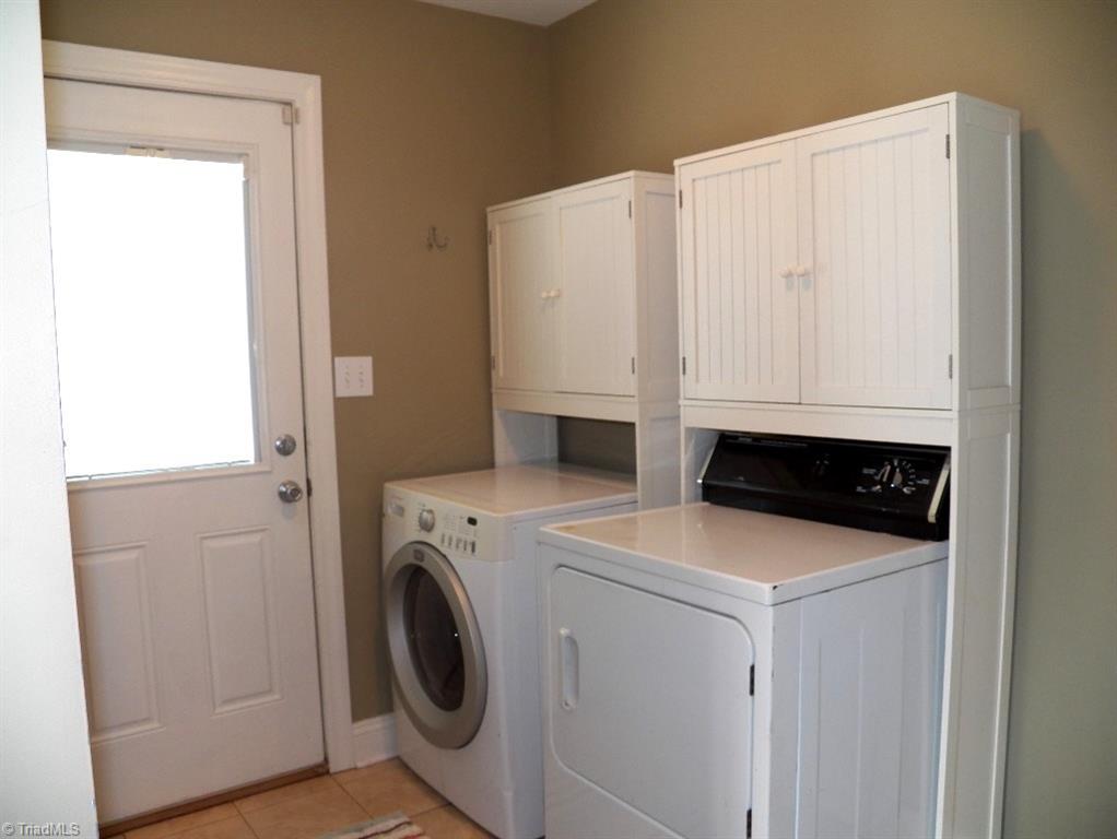 859 Riverview Rd Extension Lexington, NC 27292 - Photo 23 of 26 Side entry door, washer and dryer, tile floors for easy clean up and coat hangers on the left wall.Access to the kitchen from this room makes bringing in the groceries convenient.