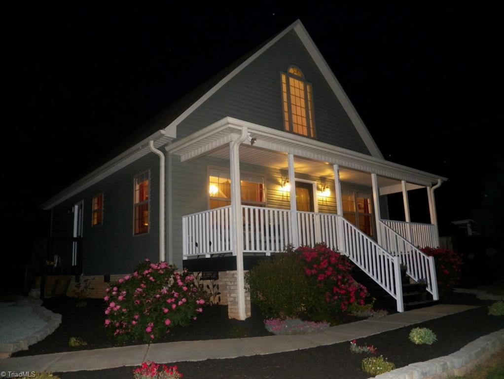 859 Riverview Rd Extension Lexington, NC 27292 - Photo 24 of 26 Night time shot of the home shows lots of warm light showing through all the windows. A cozy and comfortable place to enjoy your evenings and nights.