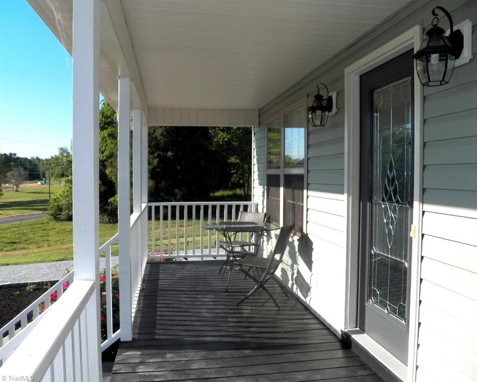 859 Riverview Rd Extension Lexington, NC 27292 - Photo 5 of 26 Covered front porch with afternoon sun and lovely views of the lake and sunsets. Great place for afternoon tea or cocktails.