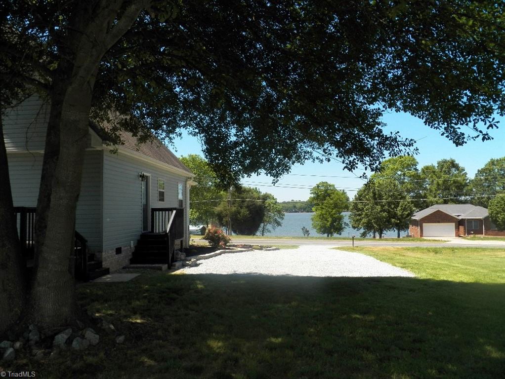 859 Riverview Rd Extension Lexington, NC 27292 - Photo 8 of 26 View from backyard straight down the driveway with lake in the background. Great place to set up some lawn furniture or lawn games. Maybe a swing set or pool?