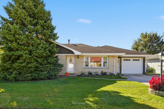 a front view of house with yard and green space