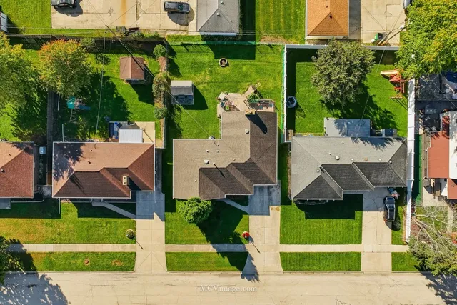 an aerial view of multiple houses with a yard