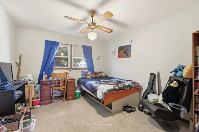 a bedroom with bed and a window