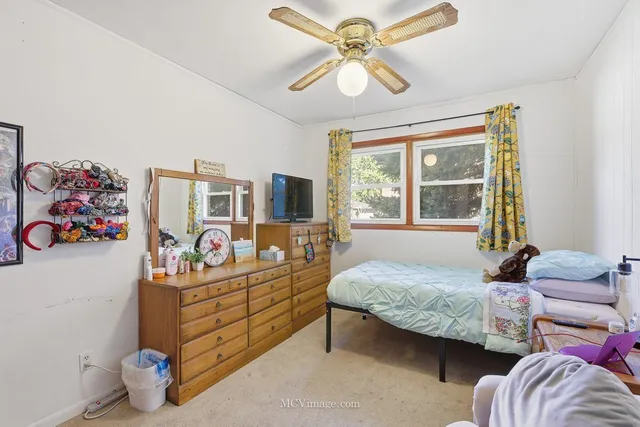 a bedroom with bed and window