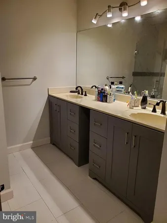 a bathroom with a double vanity sink a and a mirror