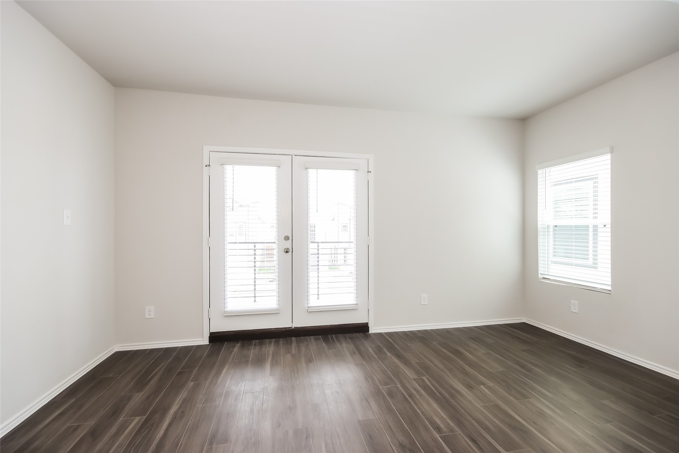 15264 Estrella Road East Houston, TX 77073 - Photo 8 of 14 an empty room with wooden floor and windows