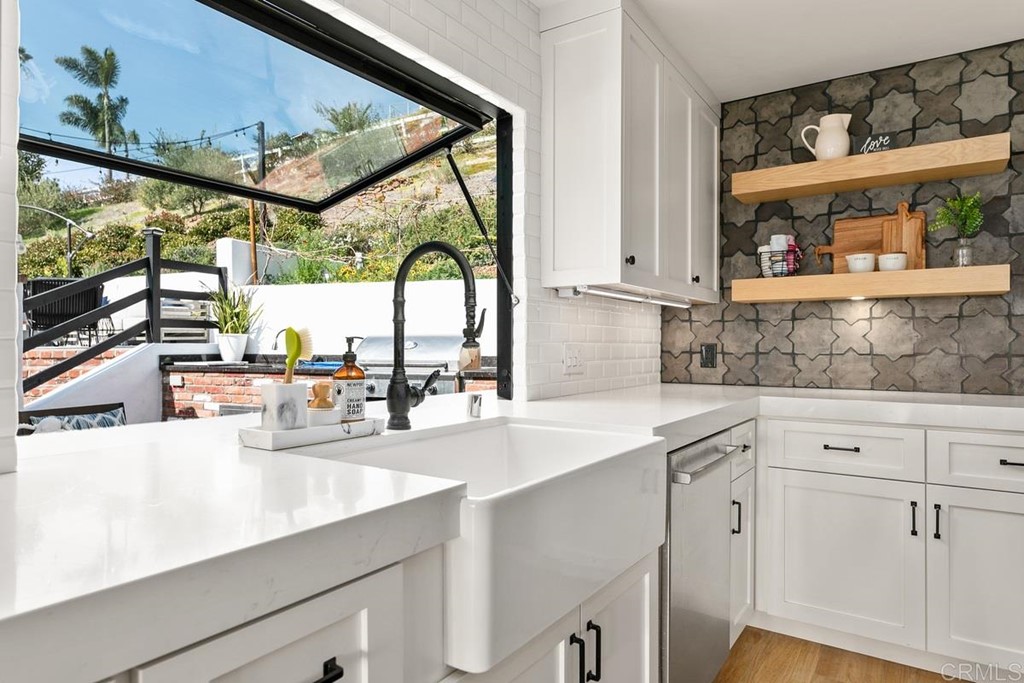 2924 Lone Jack Road Encinitas, CA 92024 - Photo 11 of 48 a kitchen with a sink and large window