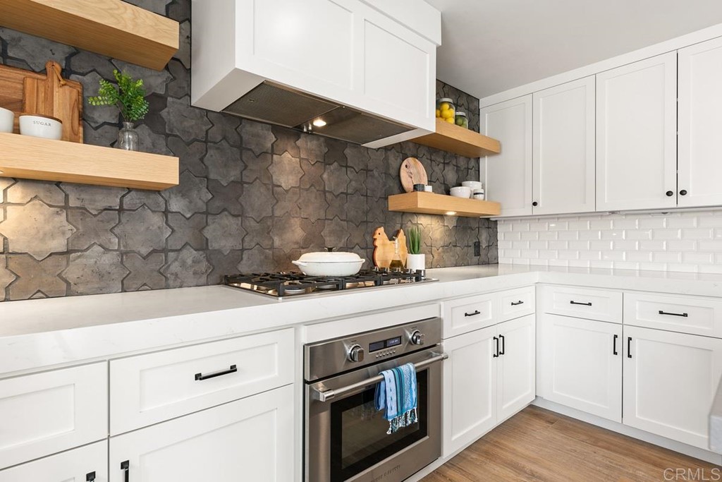 2924 Lone Jack Road Encinitas, CA 92024 - Photo 12 of 48 a kitchen with stainless steel appliances white cabinets and a stove