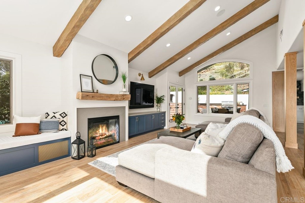 2924 Lone Jack Road Encinitas, CA 92024 - Photo 14 of 48 a living room with furniture a fireplace and a large window