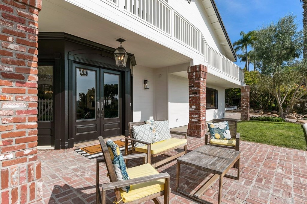 2924 Lone Jack Road Encinitas, CA 92024 - Photo 2 of 48 a view of a patio with table and chairs with plants and trees