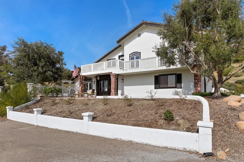 2924 Lone Jack Road Encinitas, CA 92024 - Photo 34 of 48 a view of a white house with a small yard and large tree
