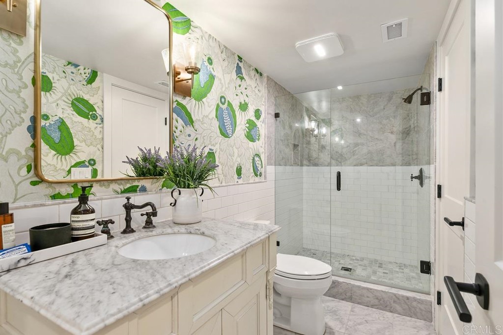 2924 Lone Jack Road Encinitas, CA 92024 - Photo 37 of 48 a bathroom with a granite countertop sink a toilet and shower