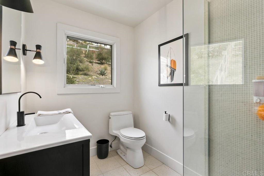 2924 Lone Jack Road Encinitas, CA 92024 - Photo 40 of 48 a bathroom with a toilet a sink and mirror