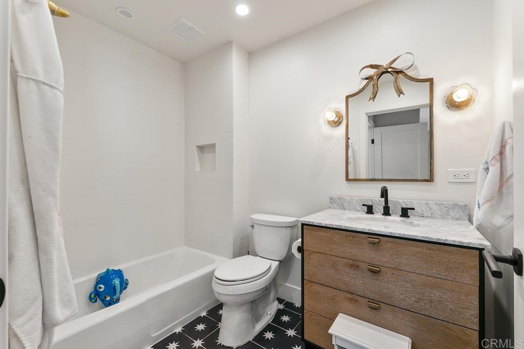 2924 Lone Jack Road Encinitas, CA 92024 - Photo 47 of 48 a bathroom with a toilet sink vanity tub and mirror