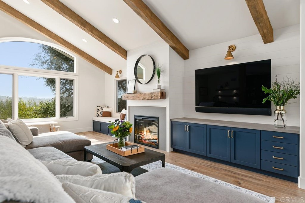 2924 Lone Jack Road Encinitas, CA 92024 - Photo 6 of 48 a living room with furniture a flat screen tv and a fireplace
