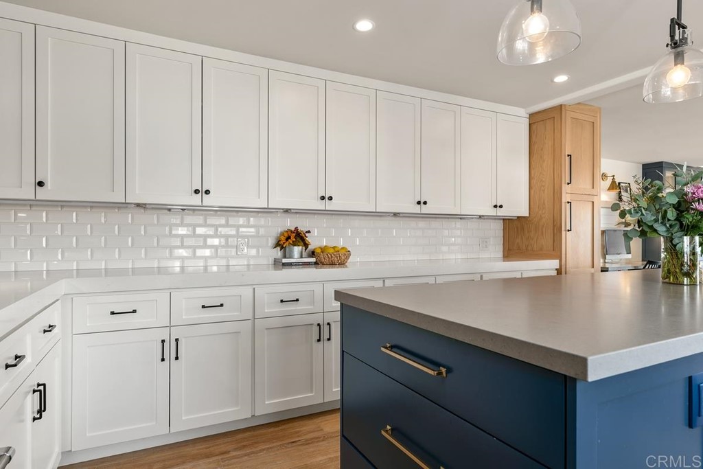 2924 Lone Jack Road Encinitas, CA 92024 - Photo 10 of 48 a kitchen with white cabinets and center island