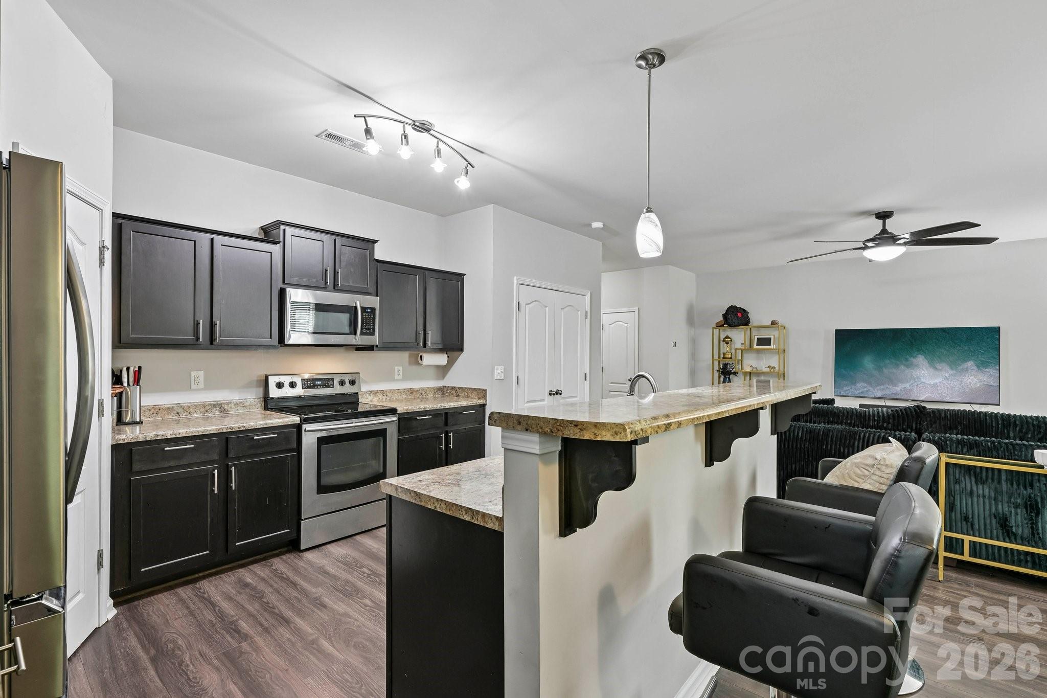 2206 Turtle Point Road Charlotte, NC 28262 - Photo 13 of 28 a large kitchen with kitchen island a stove a sink a center island and furniture