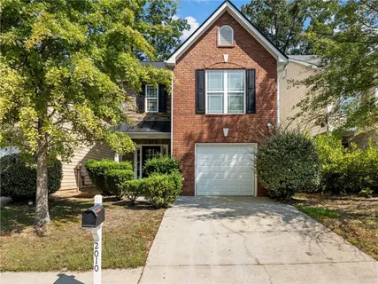 a front view of a house with garden