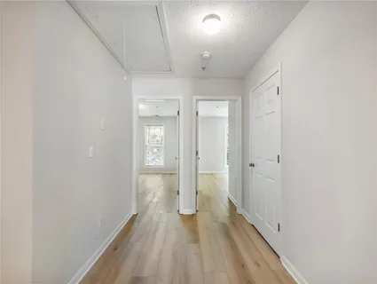 a view of a hallway with wooden floor