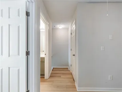 a view of hallway with wooden floor