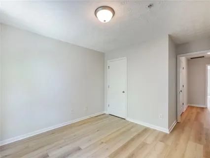 a view of an empty room and wooden floor