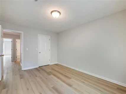wooden floor in a hall with an empty room