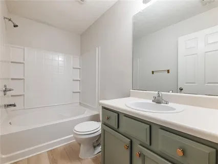 a bathroom with a sink a toilet and a bathtub