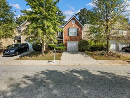 a view of a house with a yard covered in snow