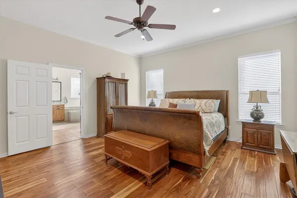 a bedroom with a bed furniture and a large window