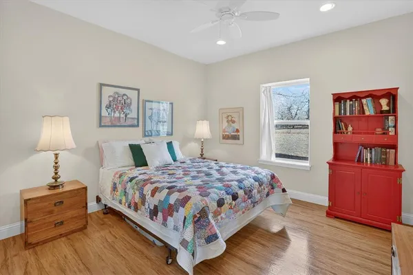 a bedroom with a large bed and a chandelier