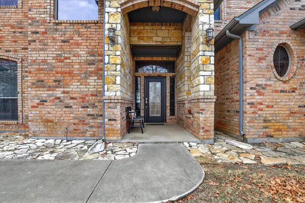 a view of a brick house with an outdoor space and garage