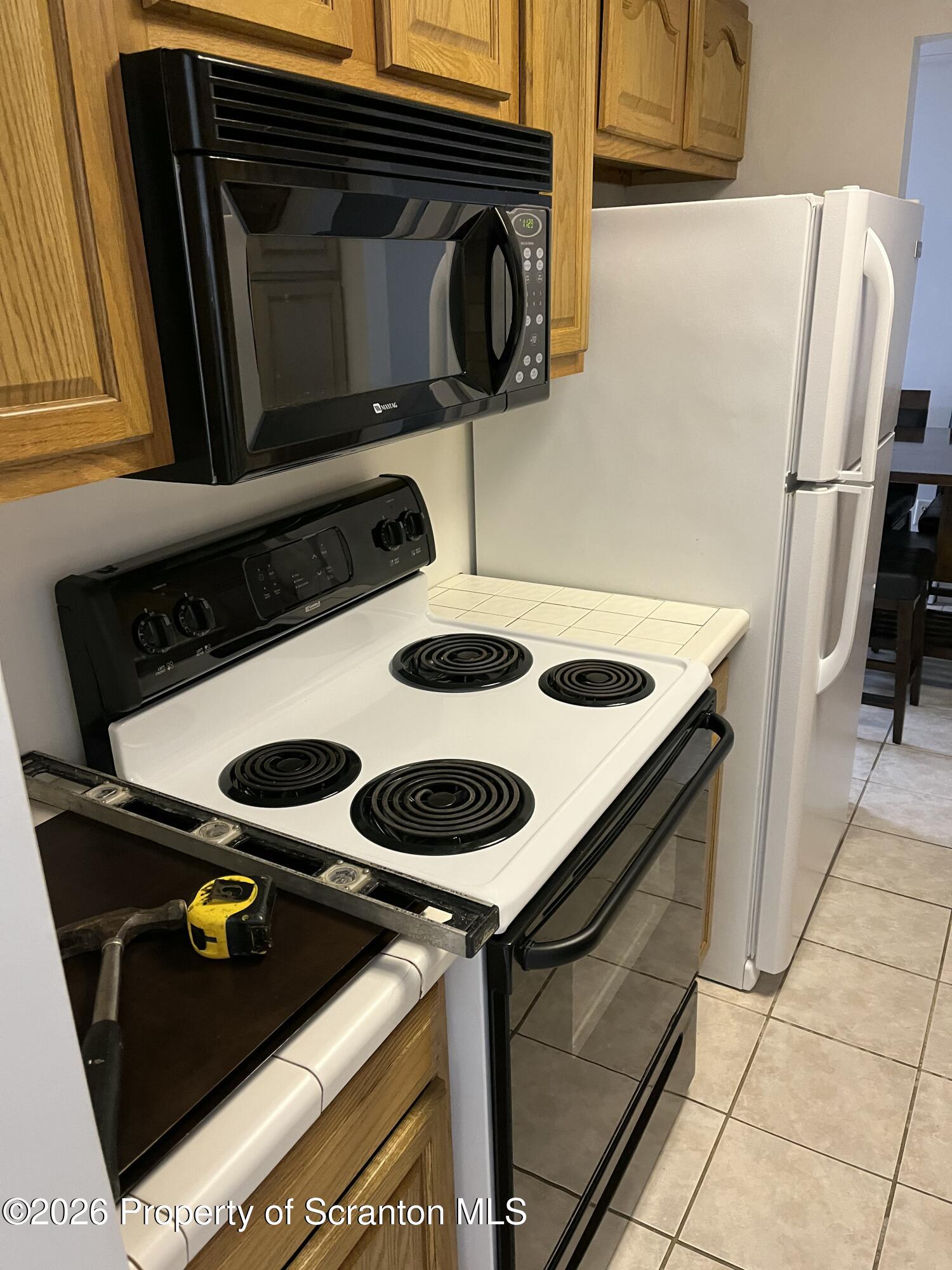 436 Ziegler Street Dupont, PA 18641 - Photo 1 of 17 a kitchen with a stove and a microwave
