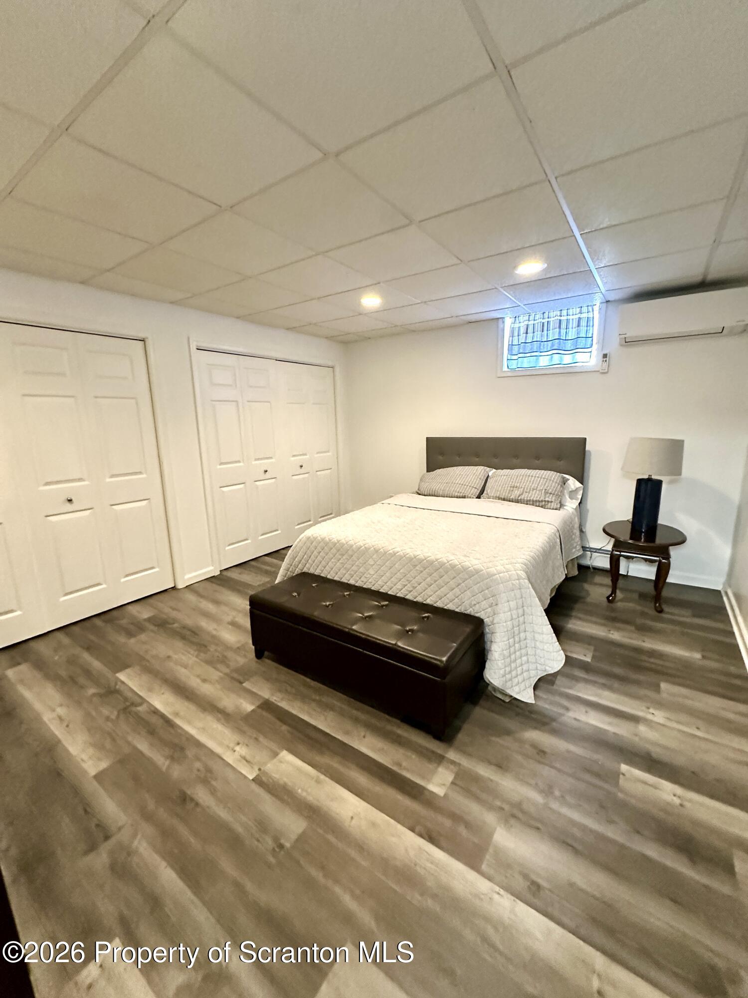 436 Ziegler Street Dupont, PA 18641 - Photo 2 of 17 a spacious bedroom with a bed and a large window