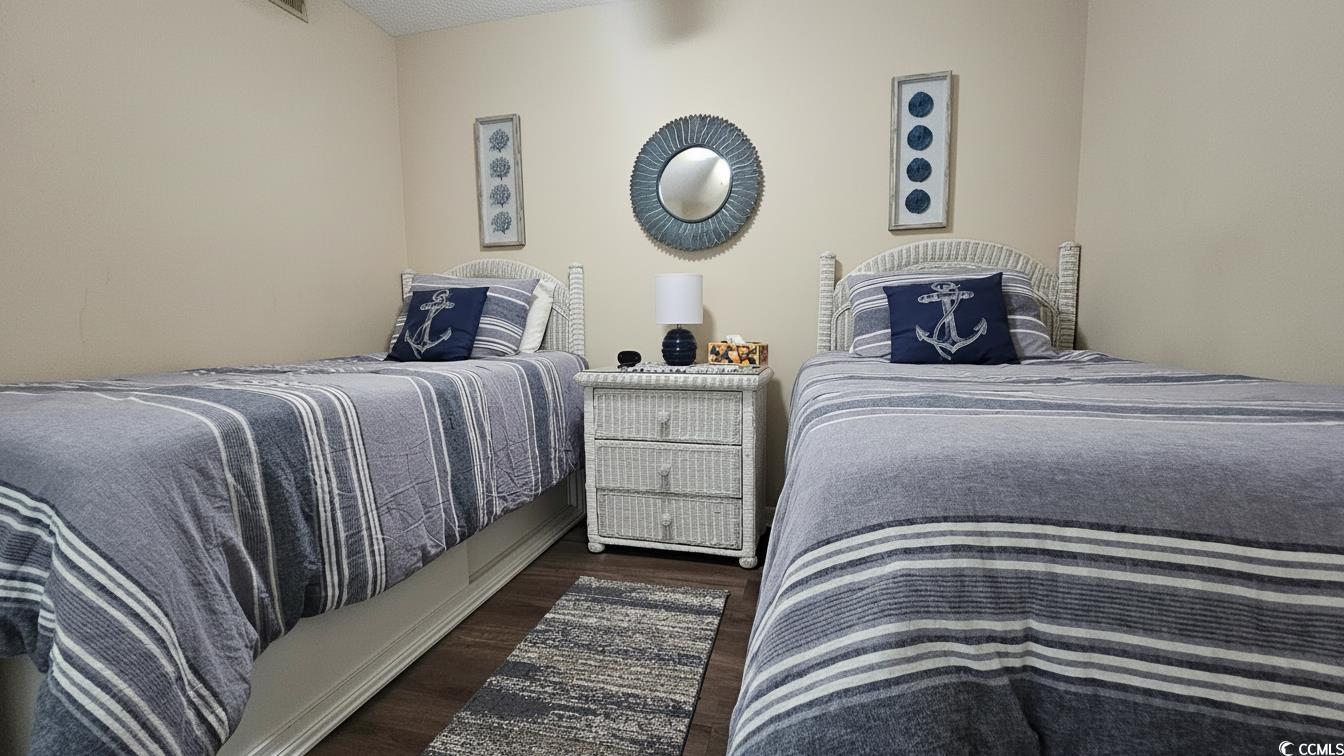 1210 North Waccamaw Drive, Unit 512 Murrells Inlet, SC 29576 - Photo 15 of 20 Bedroom featuring dark wood-style floors