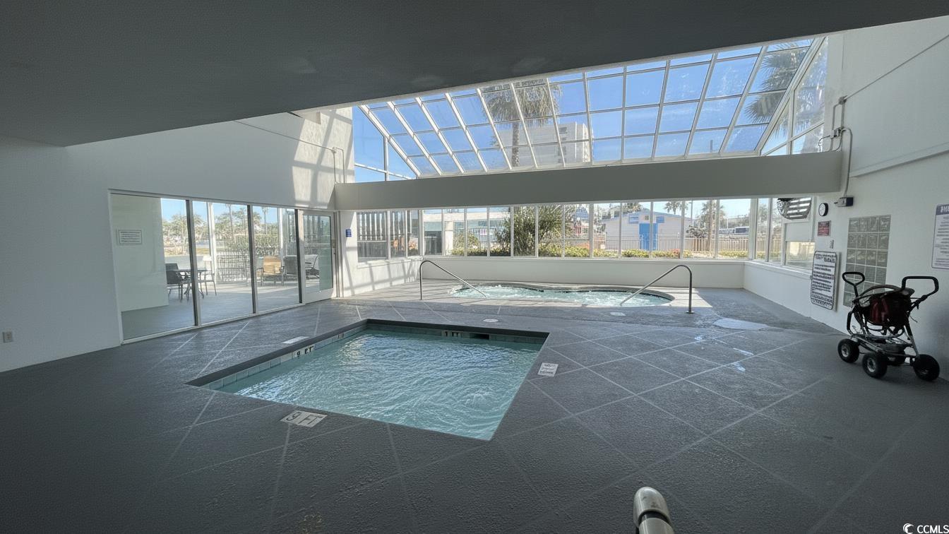 1210 North Waccamaw Drive, Unit 512 Murrells Inlet, SC 29576 - Photo 19 of 20 Community pool with a sunroom