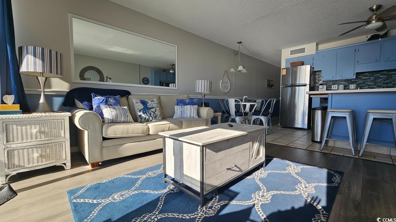 1210 North Waccamaw Drive, Unit 512 Murrells Inlet, SC 29576 - Photo 7 of 20 Living room featuring a ceiling fan, a textured ceiling, and dark wood-style flooring